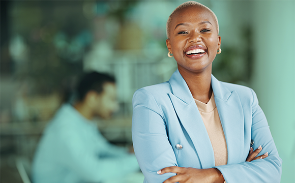 Happy African American, female lease accounting professional,looking forward with arms crossed