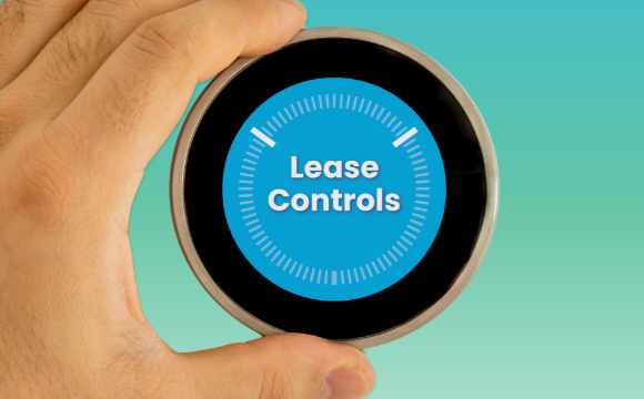 a hand turning a thermostat, the thermostat reads 
