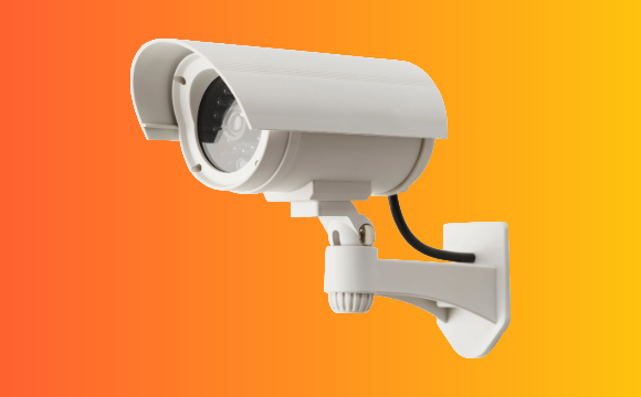 Security camera against an orange and yellow gradient background